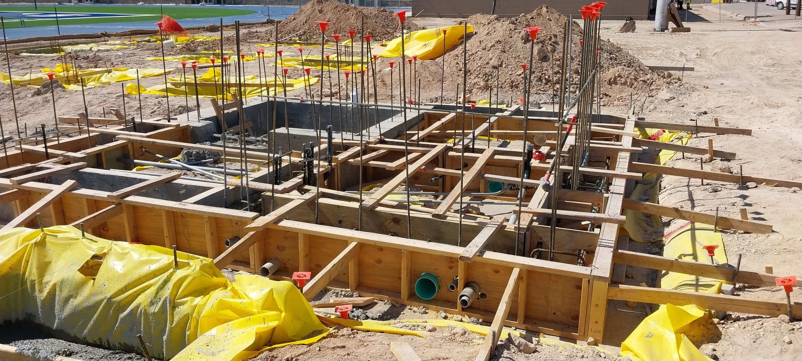 Foundation formwork and rebar on an active construction site